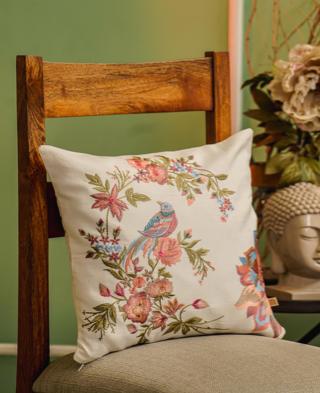 Elegant embroidered cushion cover featuring vibrant flowers and birds, enhancing home decor with a luxurious touch.